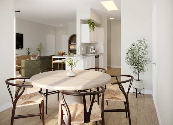 A modern dining room with a round table and chairs.