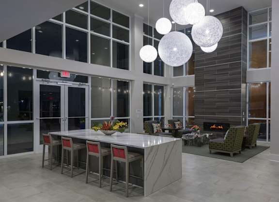 A modern dining room with a fireplace and a long table.