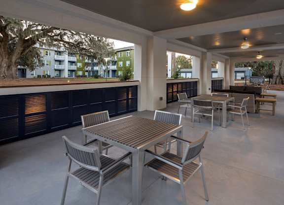 A patio with a table and chairs.