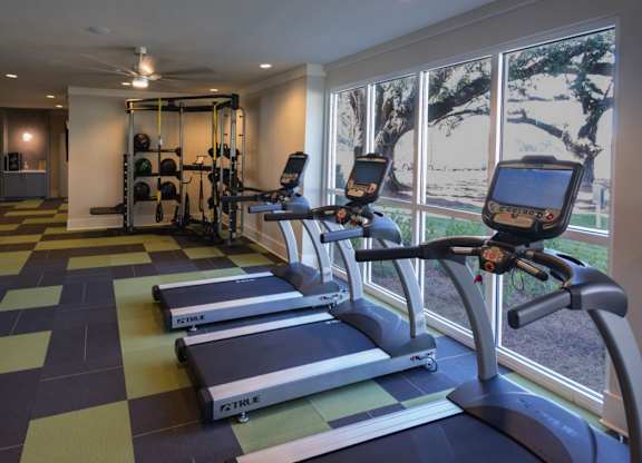 A gym with treadmills and other exercise equipment.