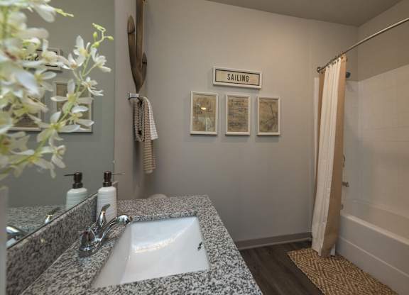 A bathroom with a sink and a sign that says "Sailing".