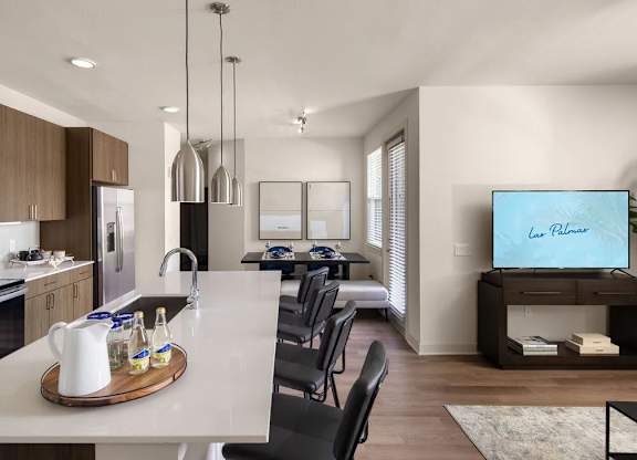 A modern kitchen with a dining table and chairs.