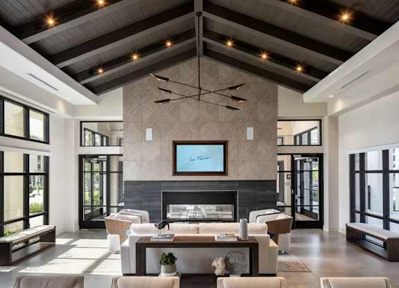A modern living room with a fireplace and a television.