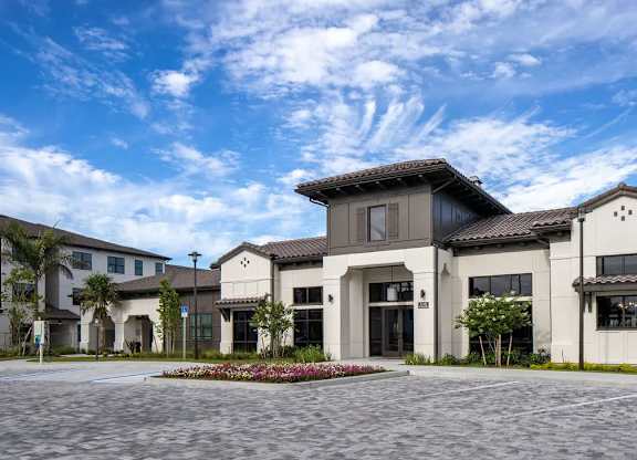 A modern building with a courtyard in front.
