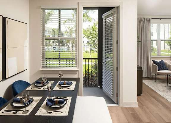 A dining room with a table set for four.