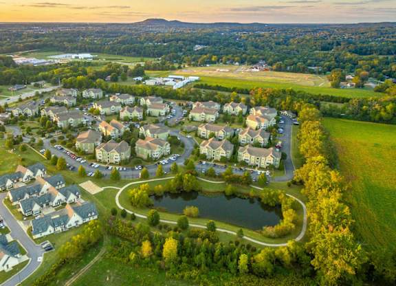 A residential area with houses and a pond.