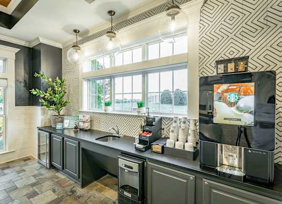 A kitchen with a black and white patterned wall.