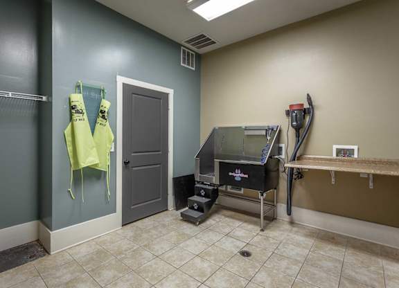 A room with a treadmill and a table.