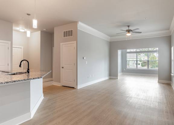 A spacious kitchen with a countertop and a ceiling fan.