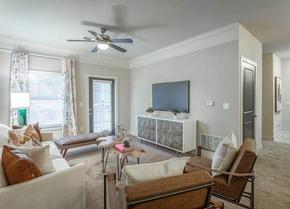 A living room with a brown chair and a white couch.