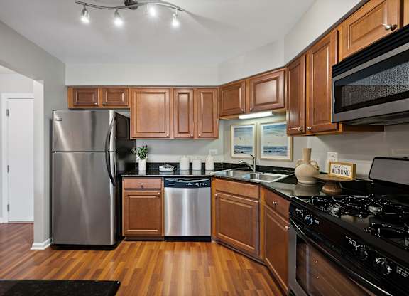 A kitchen with wooden cabinets and a black stove top oven.