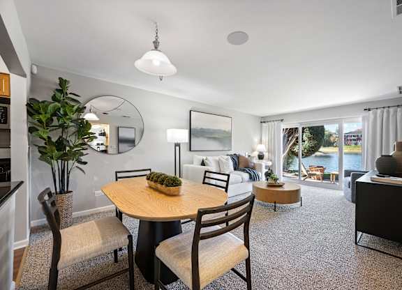 A dining room with a round table and chairs.