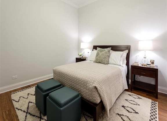 Bedroom with cozy bed and lights at Wells Place Apartments, Chicago, IL, 60607