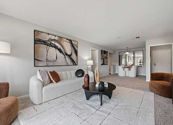 A modern living room with a large abstract painting on the wall.