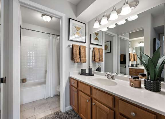 A bathroom with a white tub and sink.