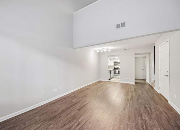 A room with wooden flooring and white walls.