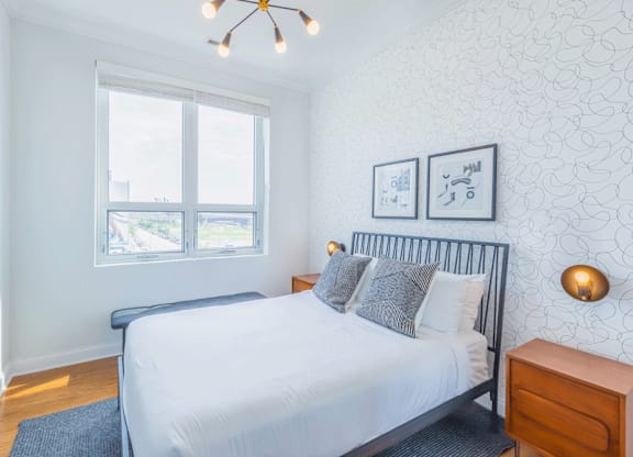 Bedroom with window at Wells Place Apartments, Chicago, IL