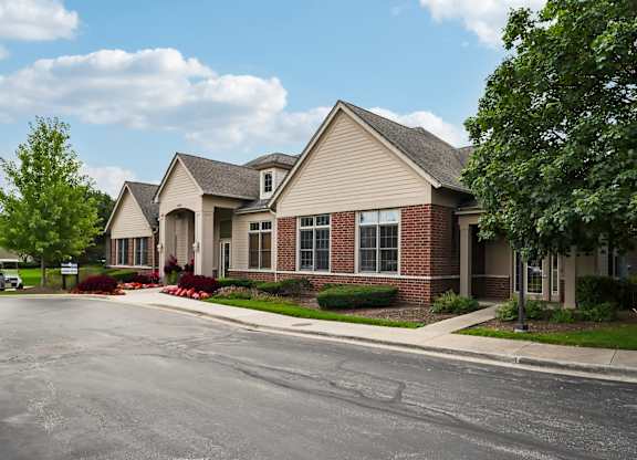 A large house with a driveway in front.