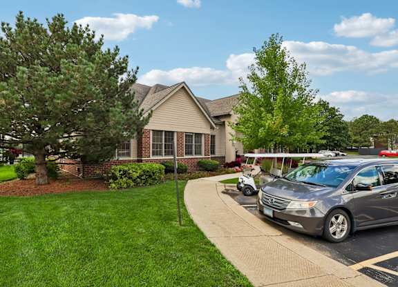 A grey car is parked in a driveway.