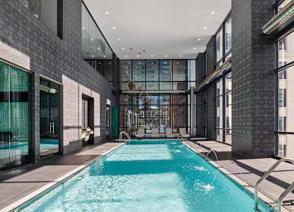 A long rectangular pool with a metal railing on the side.