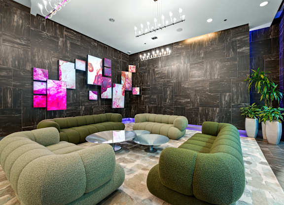 A room with a grey and brown wall and a green couch.