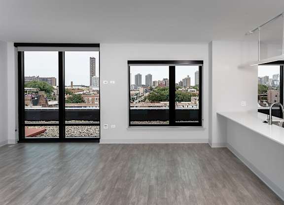 a kitchen with a large window and a white counter top at Residences at Addison Clark Apartments, Chicago, IL