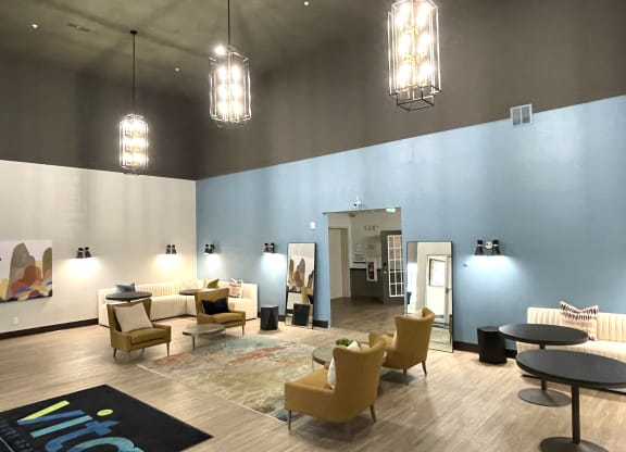 a large lobby with chairs and tables and lights