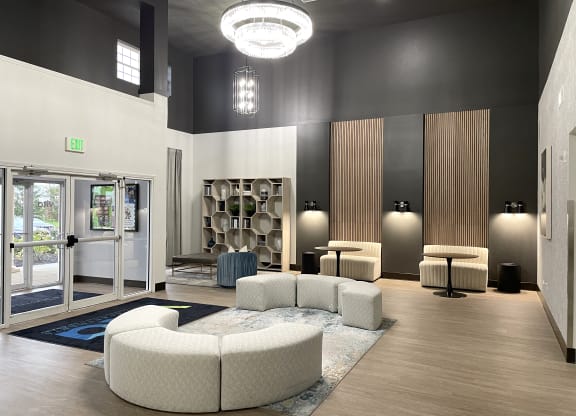 a lobby with couches and chairs and a glass door