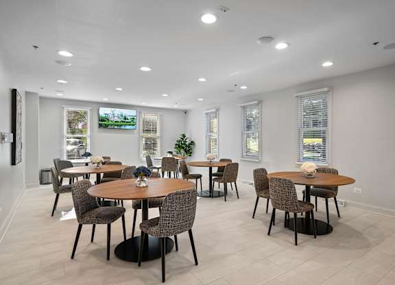 A dining room with a table set for six people.