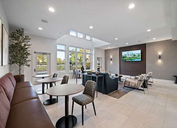 A modern living room with a television and comfortable seating.