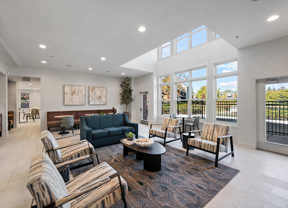 A spacious living room with a large window and a view of the outside.