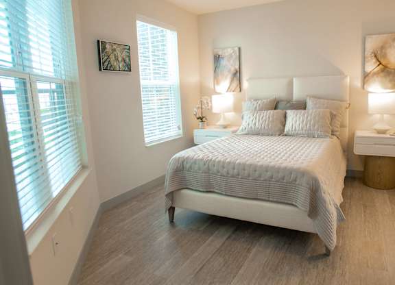 a bedroom with a bed and two windows at 42 Hundred On The Lake, Wisconsin, 53235