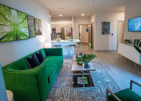 a living room with green couches and a coffee table at 42 Hundred On The Lake, St Francis, WI, 53235