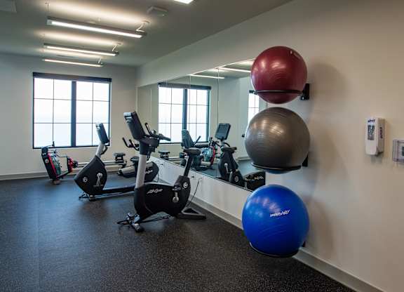 a gym with exercise equipment and weights in a building at 42 Hundred On The Lake, St Francis