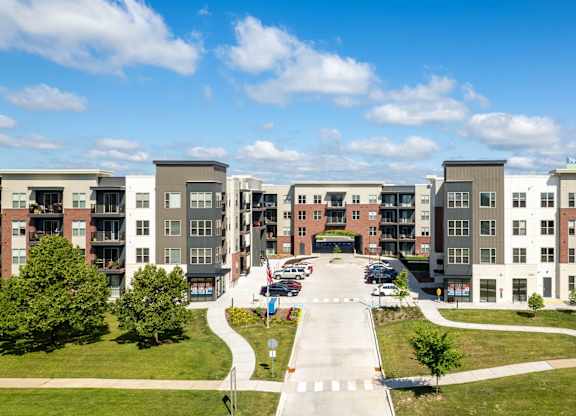 A view of a road with apartment buildings on both sides. at Elevate Apartments, Madison, WI