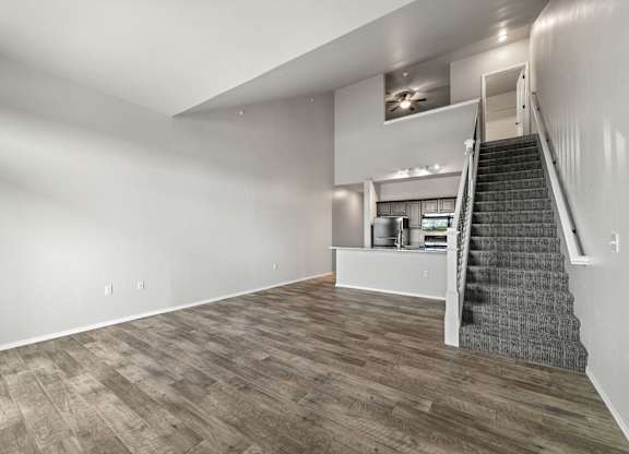 A room with a staircase and a counter in the background.