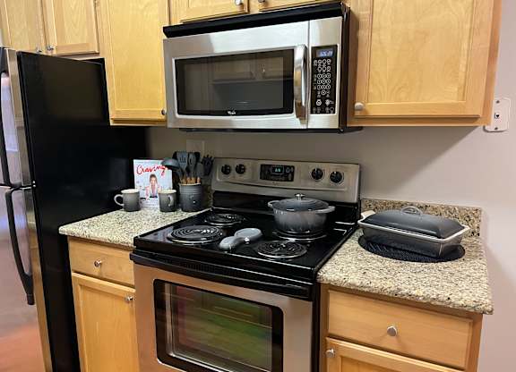 a kitchen with a stove and a microwave at Fieldpointe of Schaumburg, Illinois, 60173