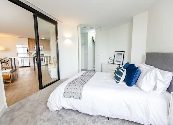 a bedroom with a large bed and a sliding glass door at The Kent, Chicago, 60614