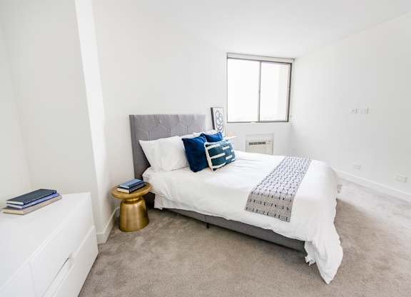 a bedroom with a bed and a window at The Kent, Chicago, Illinois