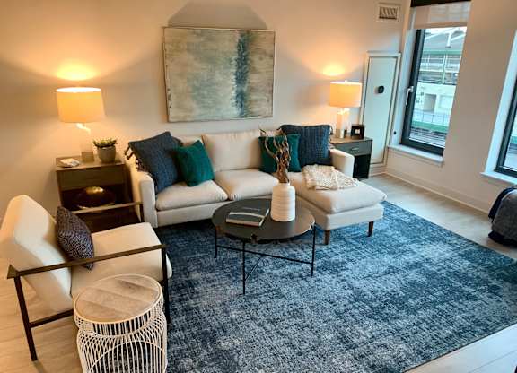 a living room with a couch and a rug at Residences at Addison Clark Apartments, Chicago, 60613