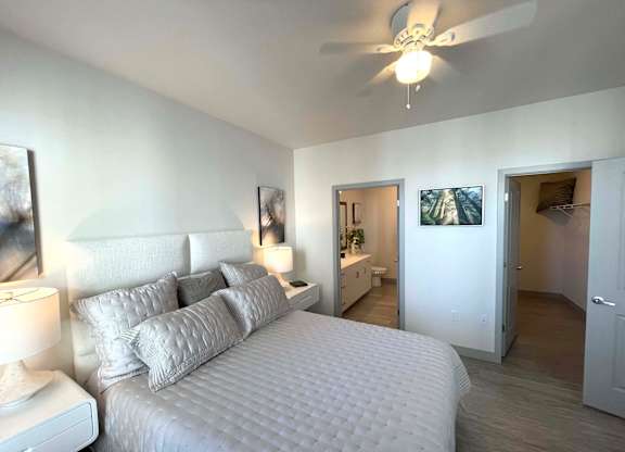 a bedroom with a large bed and a ceiling fan at 42 Hundred On The Lake, St Francis