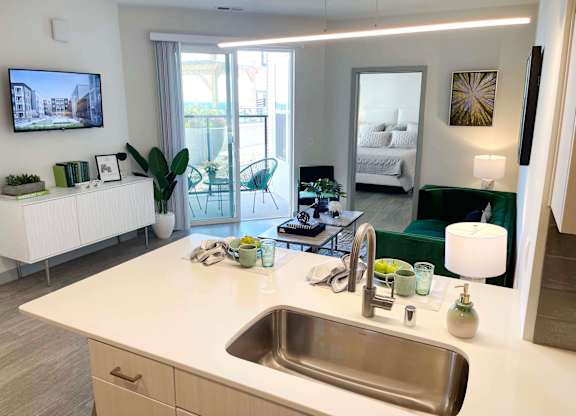 a kitchen with a sink and a view of a living room at 42 Hundred On The Lake, Wisconsin, 53235