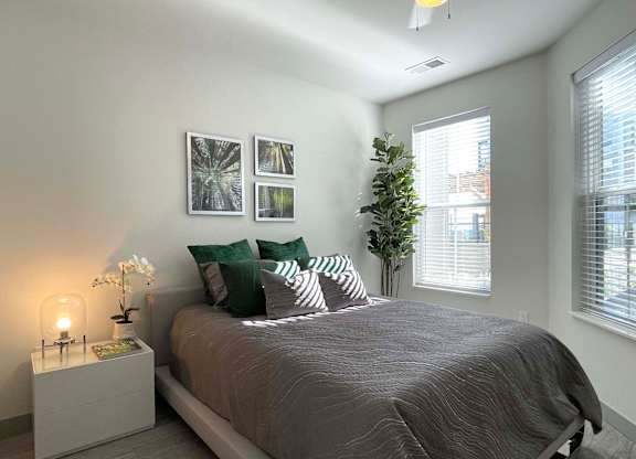 a bedroom with a bed and two windows at 42 Hundred On The Lake, St Francis, WI, 53235
