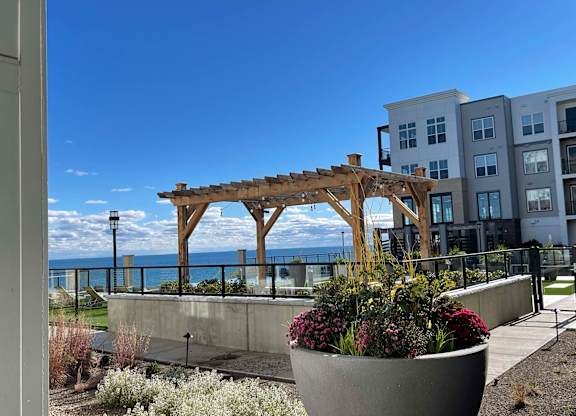 a view of the ocean from a building with a wooden structure at 42 Hundred On The Lake, St Francis, WI