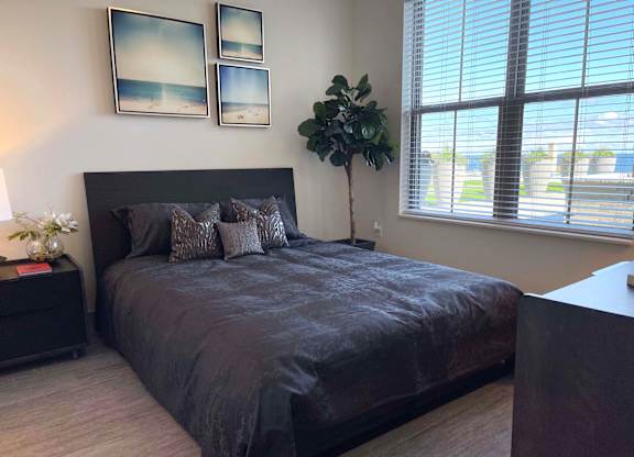 a bedroom with a large bed and a window at 42 Hundred On The Lake, St Francis, 53235
