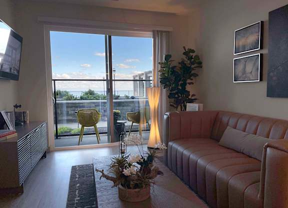 a living room with a couch and a balcony at 42 Hundred On The Lake, St Francis, WI