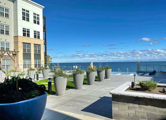 a view of the ocean from a building with potted plants at 42 Hundred On The Lake, St Francis, WI, 53235
