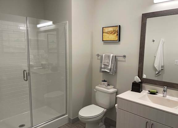 a bathroom with a shower toilet and sink at 42 Hundred On The Lake, St Francis