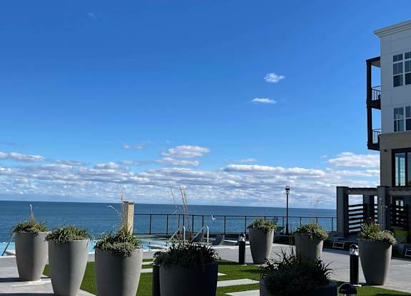 a view of the ocean from a building with potted plants at 42 Hundred On The Lake, St Francis, WI, 53235