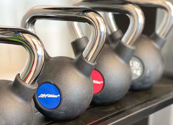a group of dumbbells sitting on a shelf at 42 Hundred On The Lake, St Francis, 53235